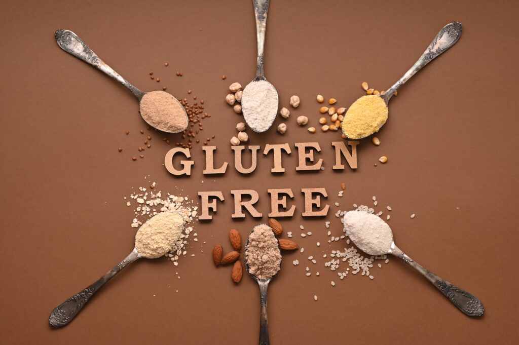 Gluten free text and spoons of various gluten free flour. Flat lay, top.