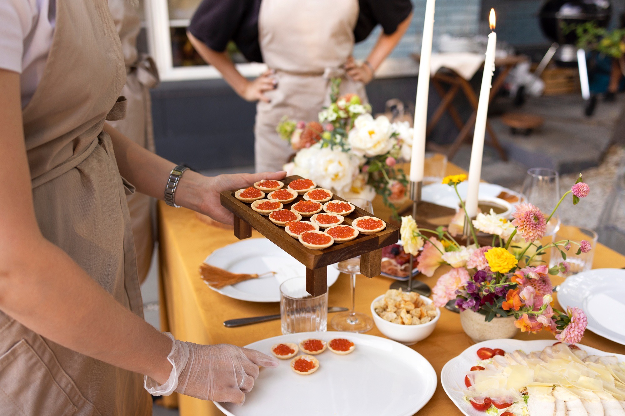 Wedding table for guests, decorated with candles, are served with cutlery and crockery